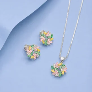 Sterling silver floral pendant and earrings set with multicolour zircon stones displayed on a pastel blue background.