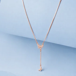 Rose gold butterfly drop necklace with zircon detailing displayed on a soft pastel blue background.