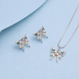 Sterling silver butterfly pendant necklace with matching butterfly earrings featuring multicolour zircon stones on a pastel blue background.