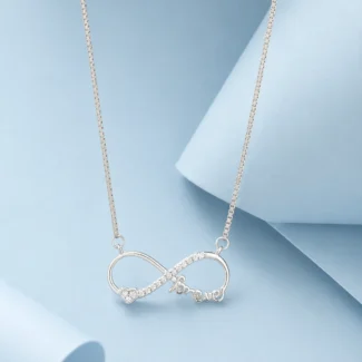 Sterling silver infinity necklace with zircon stone detailing and “forever” script pendant displayed on a soft pastel blue luxury background.
