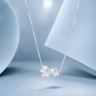 Sterling silver butterfly necklace with zircon stones and mother of pearl accents displayed on a pastel blue luxury background