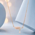 Sterling silver floral pendant necklace with white bloom charm and zircon detailing displayed on a pastel blue background.