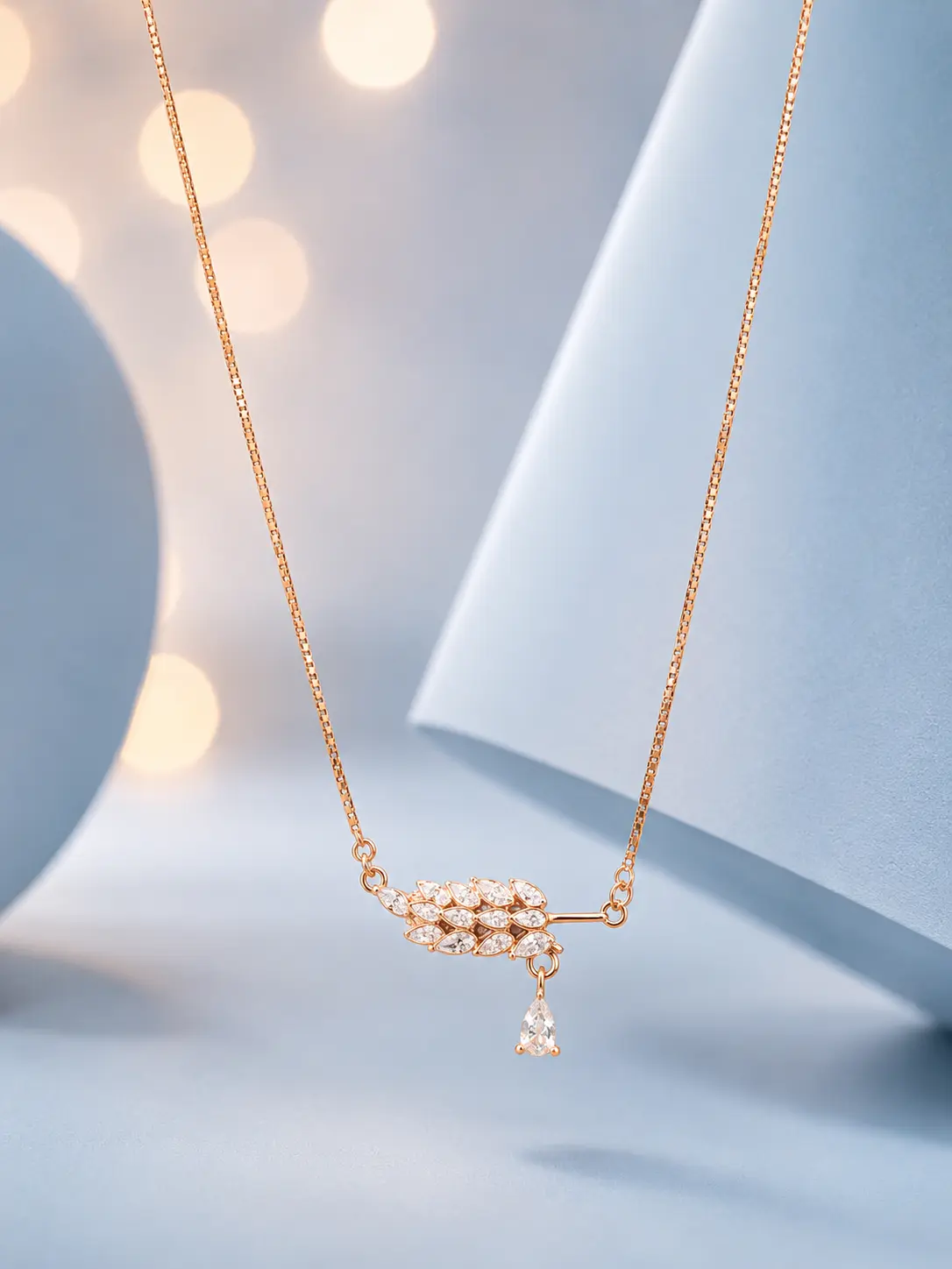 website image drop stone rose gold Sterling silver floral pendant necklace with white bloom charm and zircon detailing displayed on a pastel blue background.