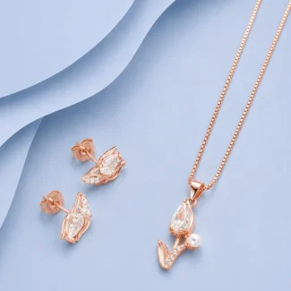 Rose gold finish 92.5 sterling silver pendant necklace with matching stud earrings featuring marquise zircon stones and pearl accents displayed on a pastel blue luxury background.